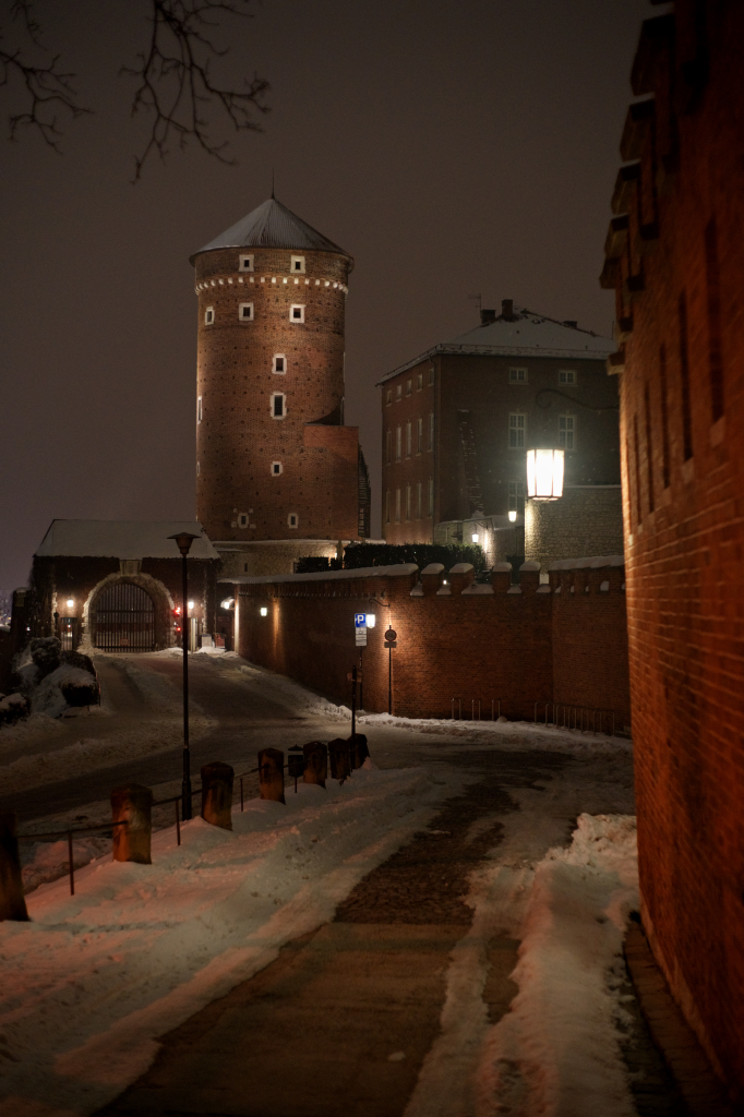 An old but well-kept brick tower and wall.